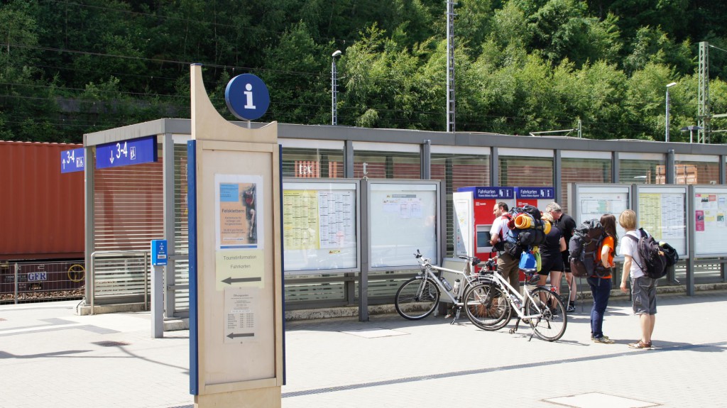 Personen am Fahrkartenautomaten am Gleis